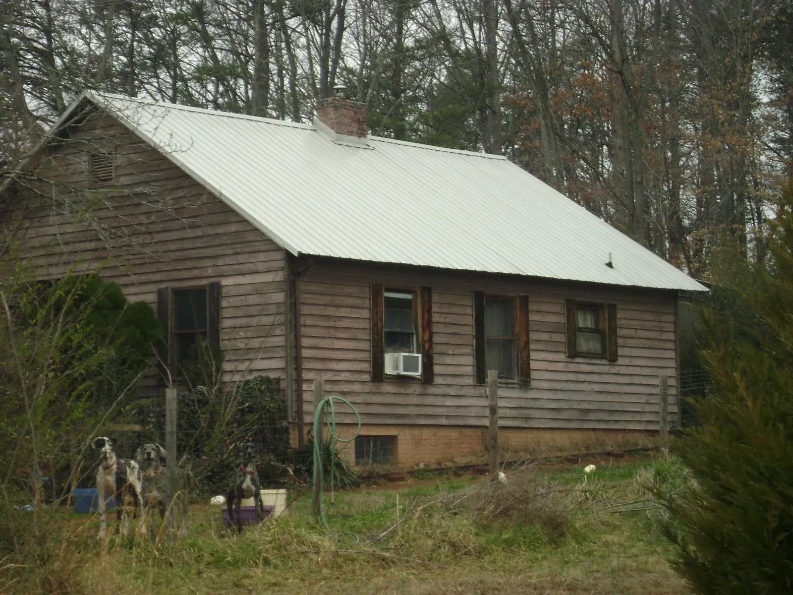 White metal roof on an old wood sided farmhouse, from a Metal Roof Installation job in Browns Valley